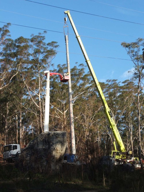 Power pole being erected in landslide zone